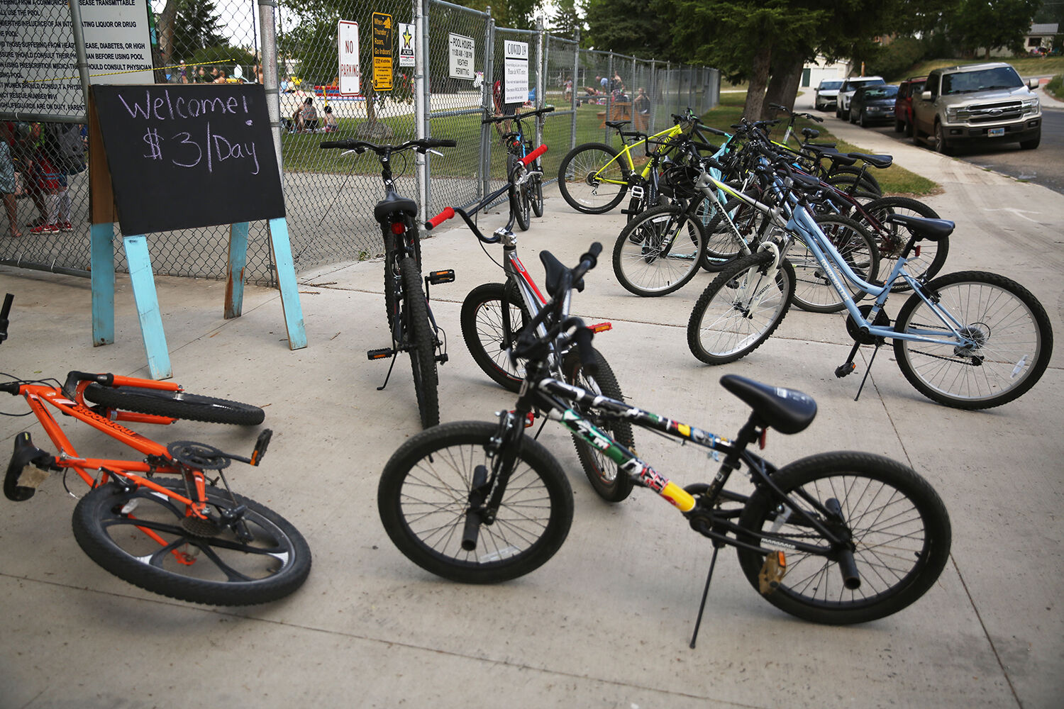 Bikes are scattered around the entrance to the pool